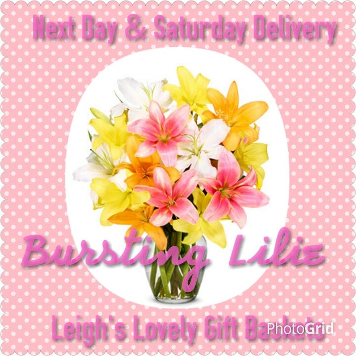 Bursting Lilie Bouquet with pink, yellow and white asiatic lilies in a clear glass vase.